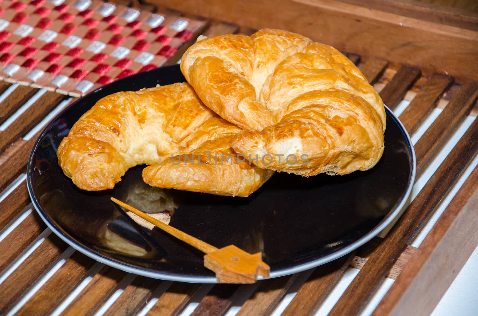 Tasty croissants bread on plate.