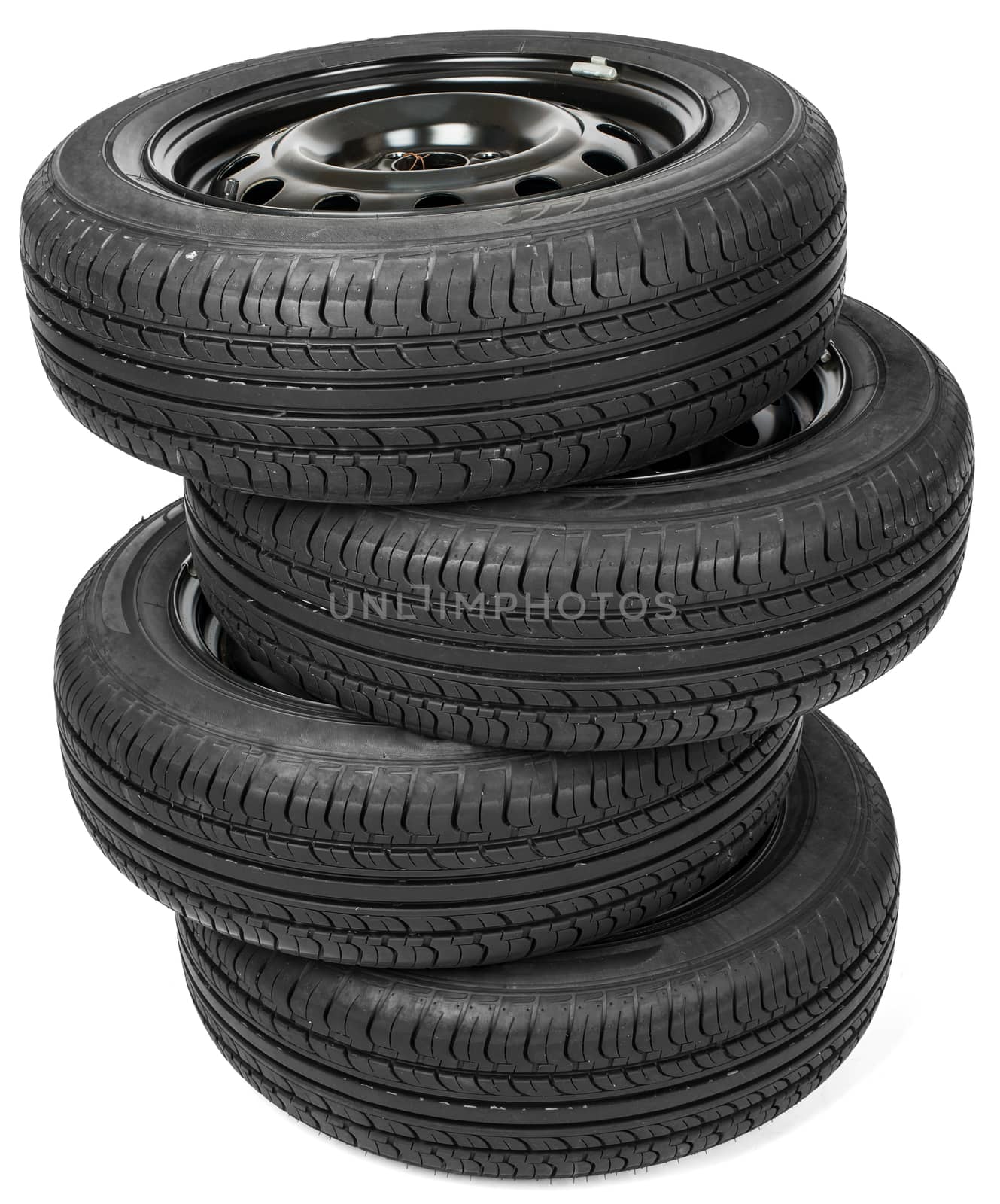 Stack of four wheel black tyres for summer isolated on white background