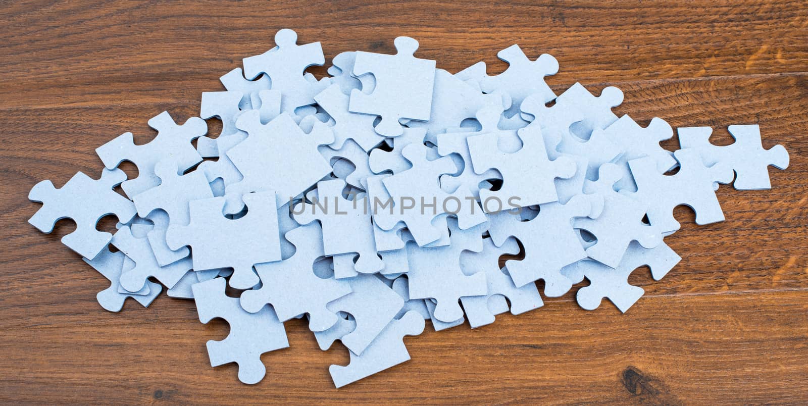 Pile of puzzle pieces on table, top view