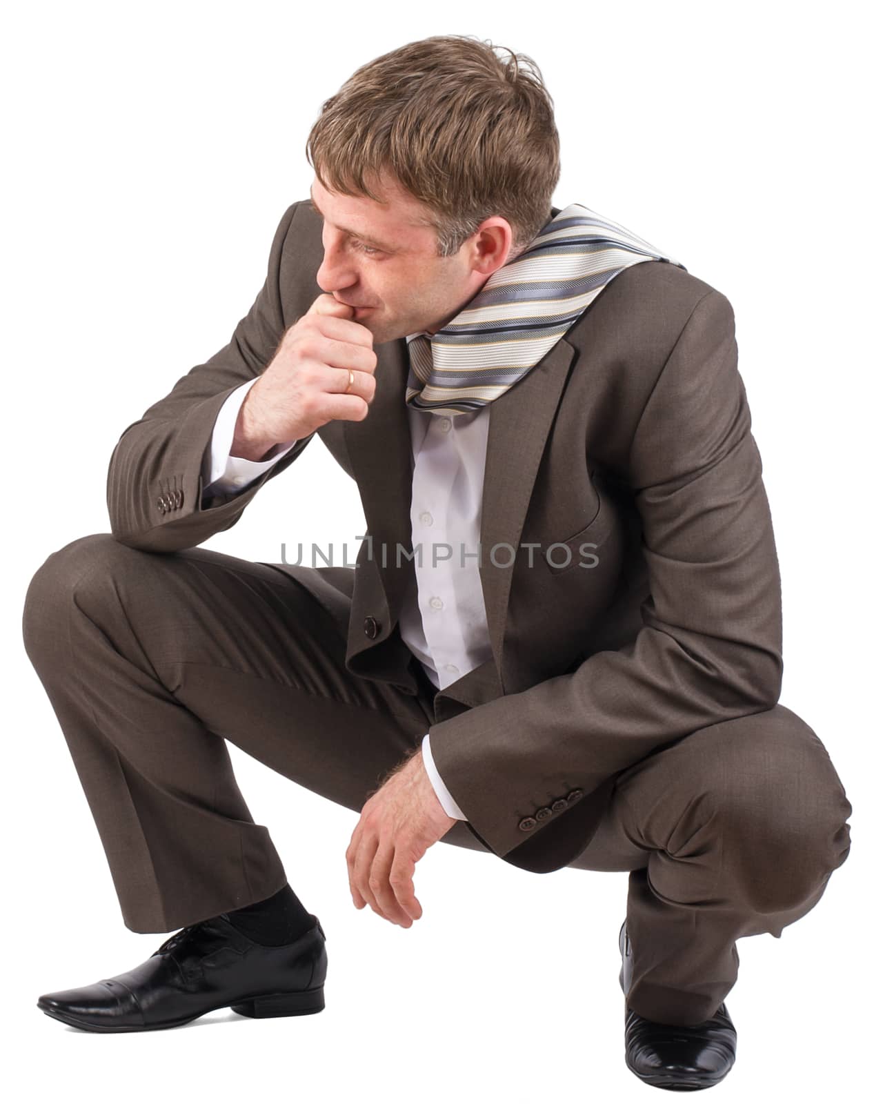 Businessman sitting on his haunches over white background