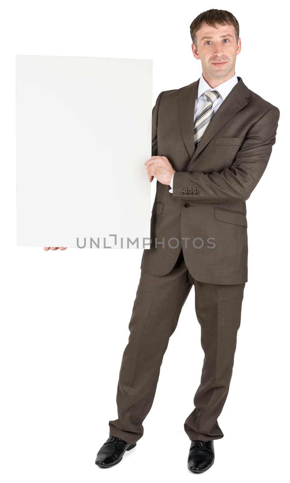 Businessman holding blank white board by cherezoff