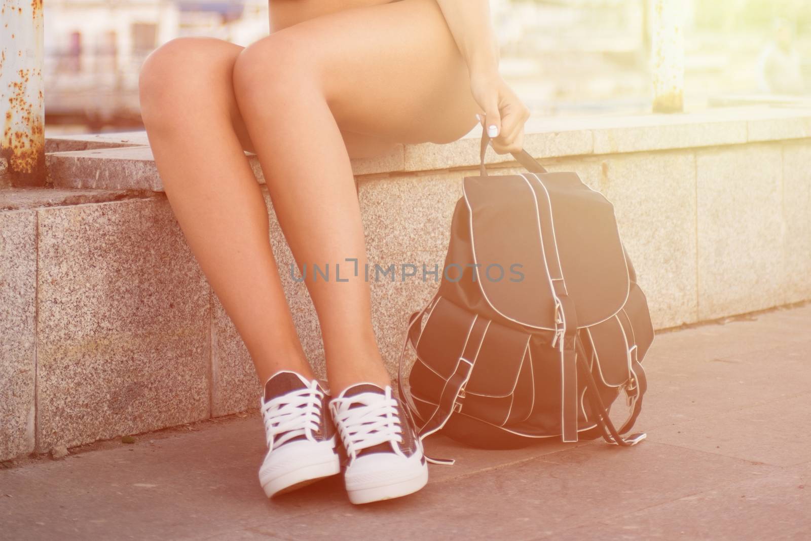 closeup of woman legs in white gumshoes, outdoor shot