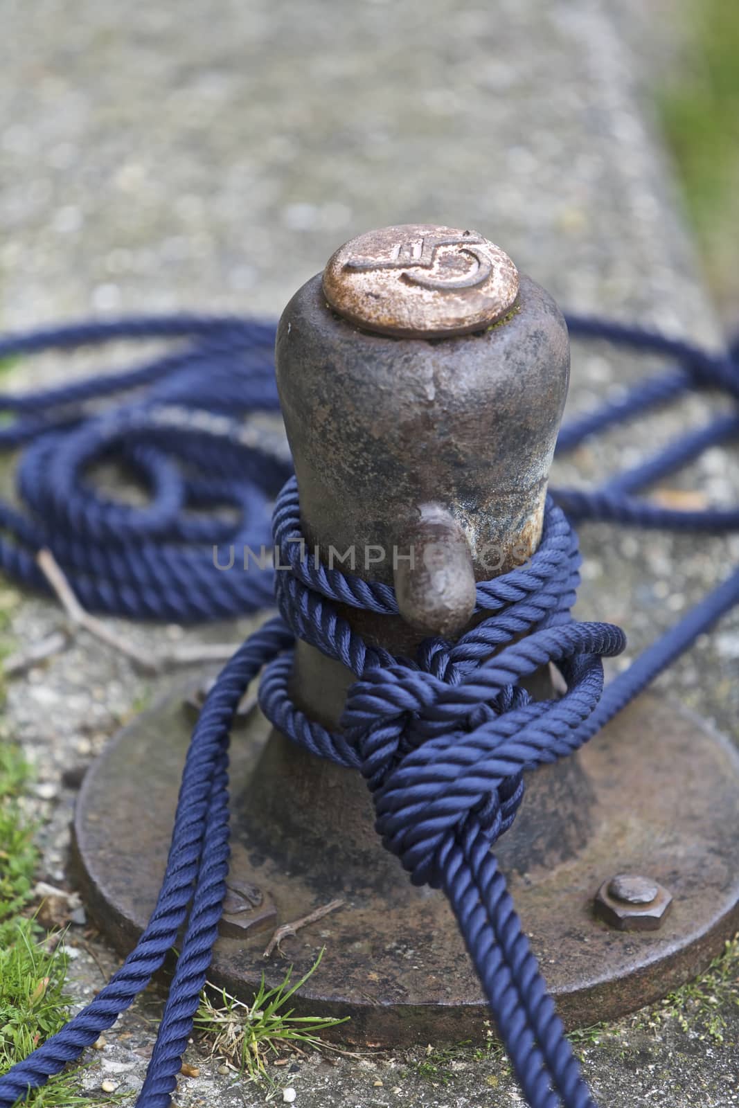 Boat anchored pole with blue rope, England