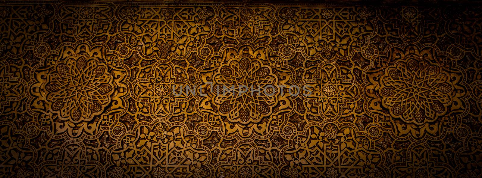 Wall detail of Alhambra UNESCO site in Granada - South of Spain. 600 years old arabic characters.