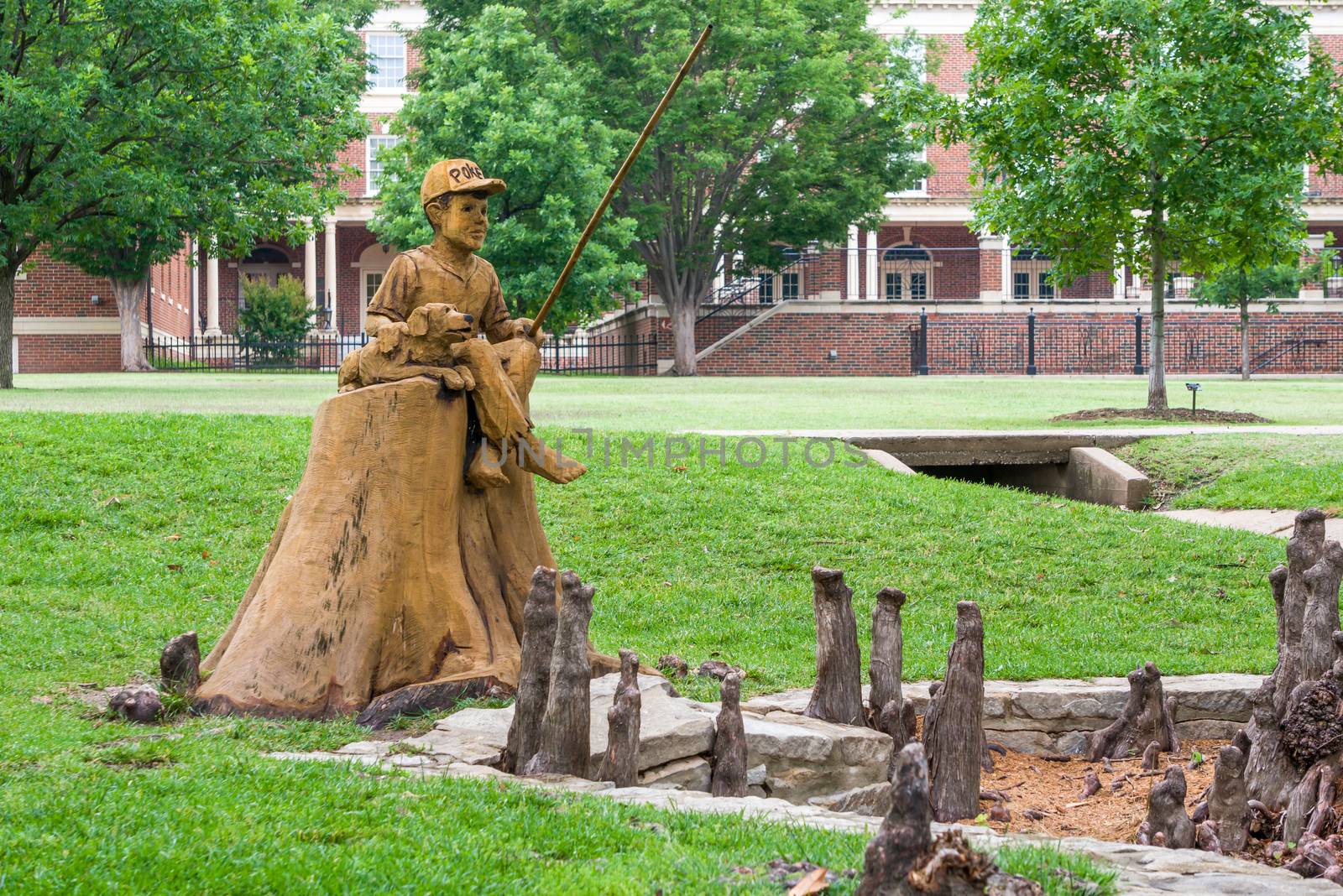 STILLWATER, OK/USA - MAY 20, 2016: Boy and Dog Fishing Sculpture at Theta Pond on the campus of Oklahoma State University.