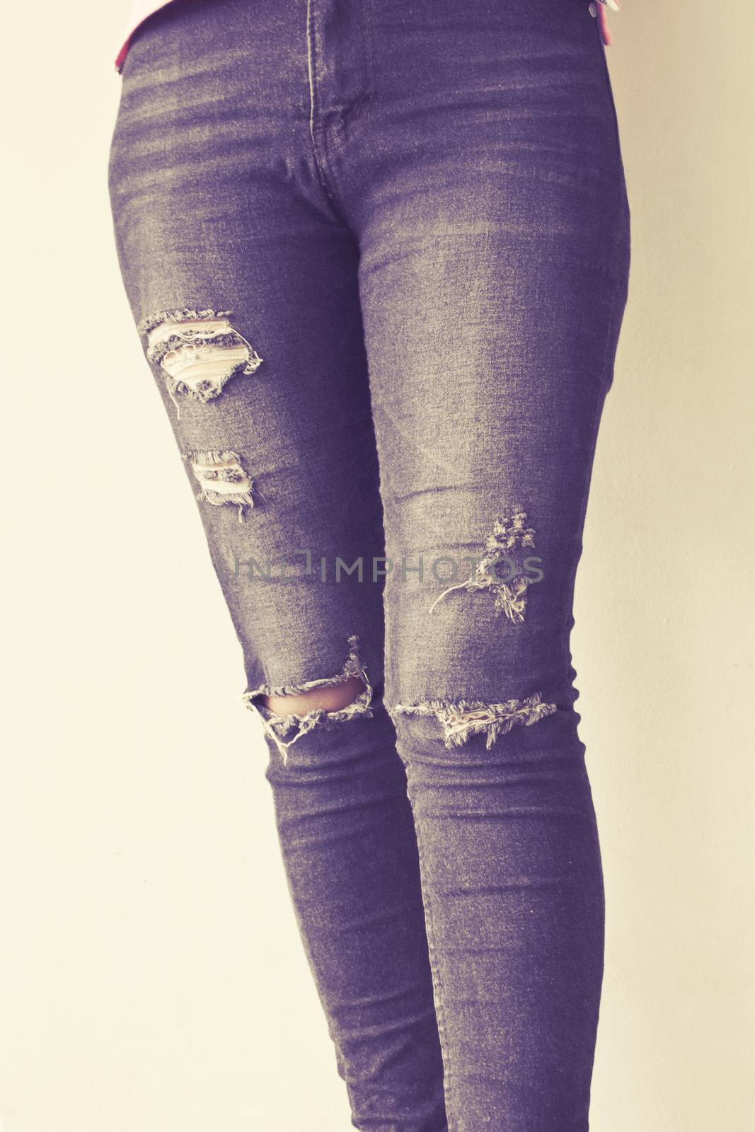 Female wearing jeans vintage tone background by worrayuth