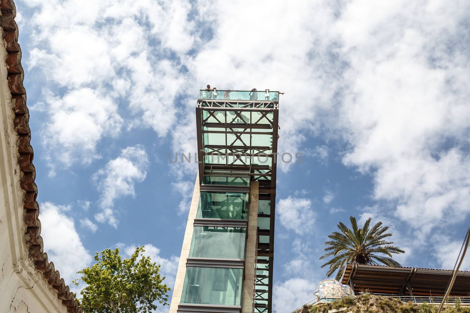 Bottom view of lift with glass observation terrace in Antalya Kaleici on cloudy blue sky background.