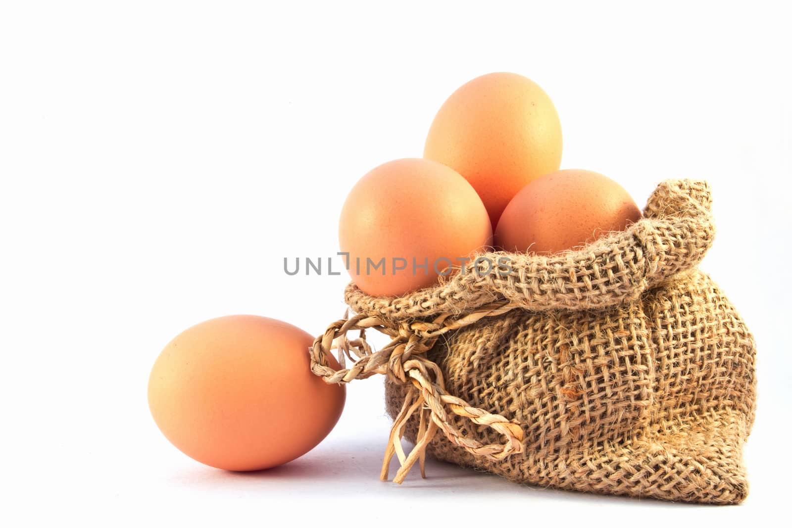 Brown eggs in canvas sack isolated on a white background 