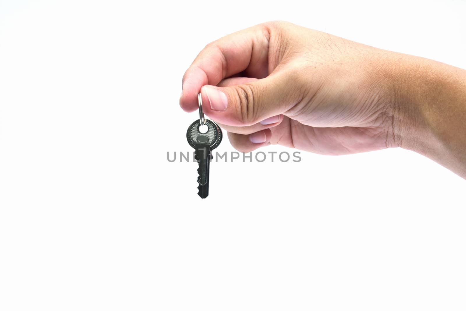 Silver key in a hand isolated on white. 
