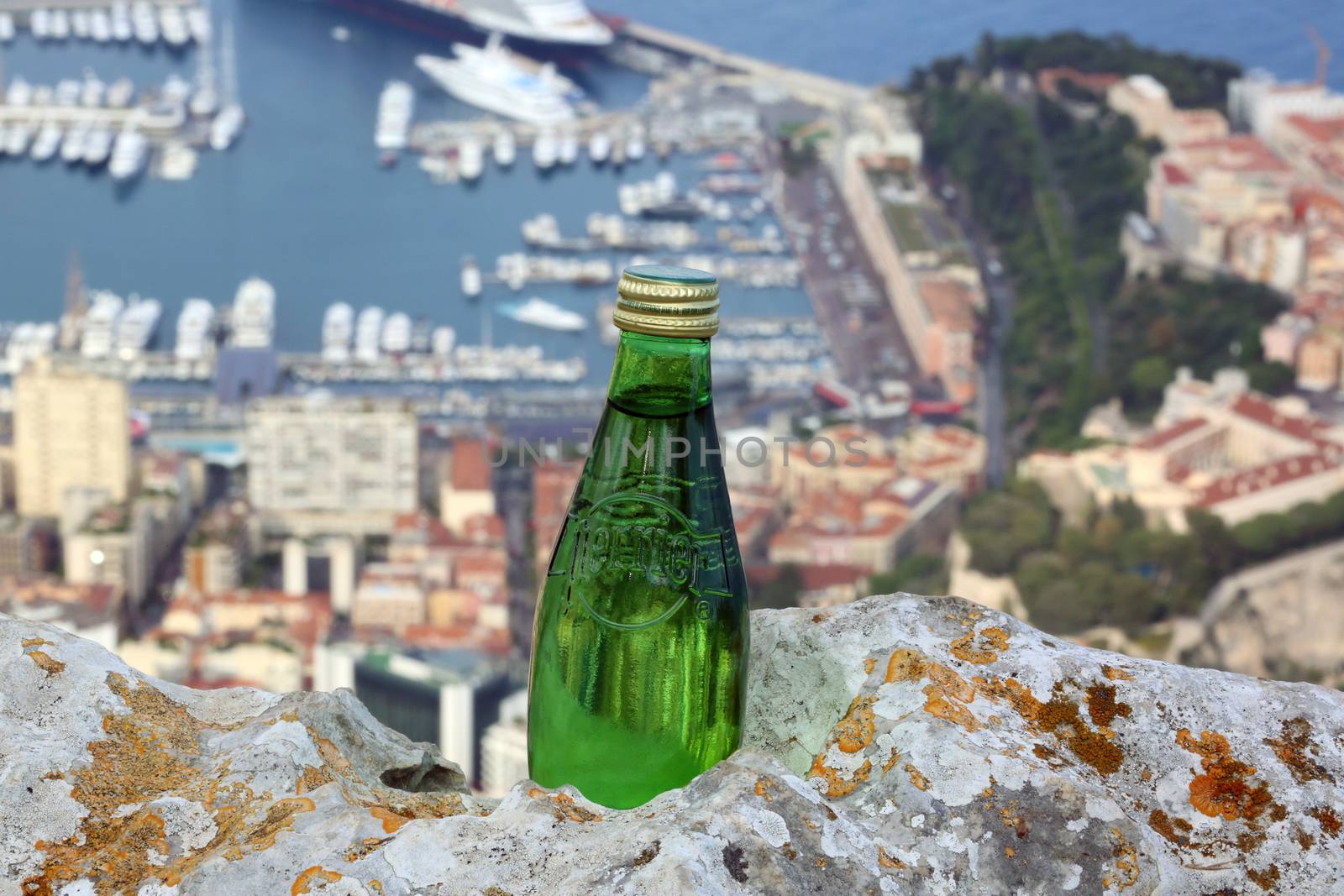 La Turbie, France - June 1, 2016: Perrier Sparkling Natural Mineral Water. Aerial View of the Port Hercule in Monaco in the Background

