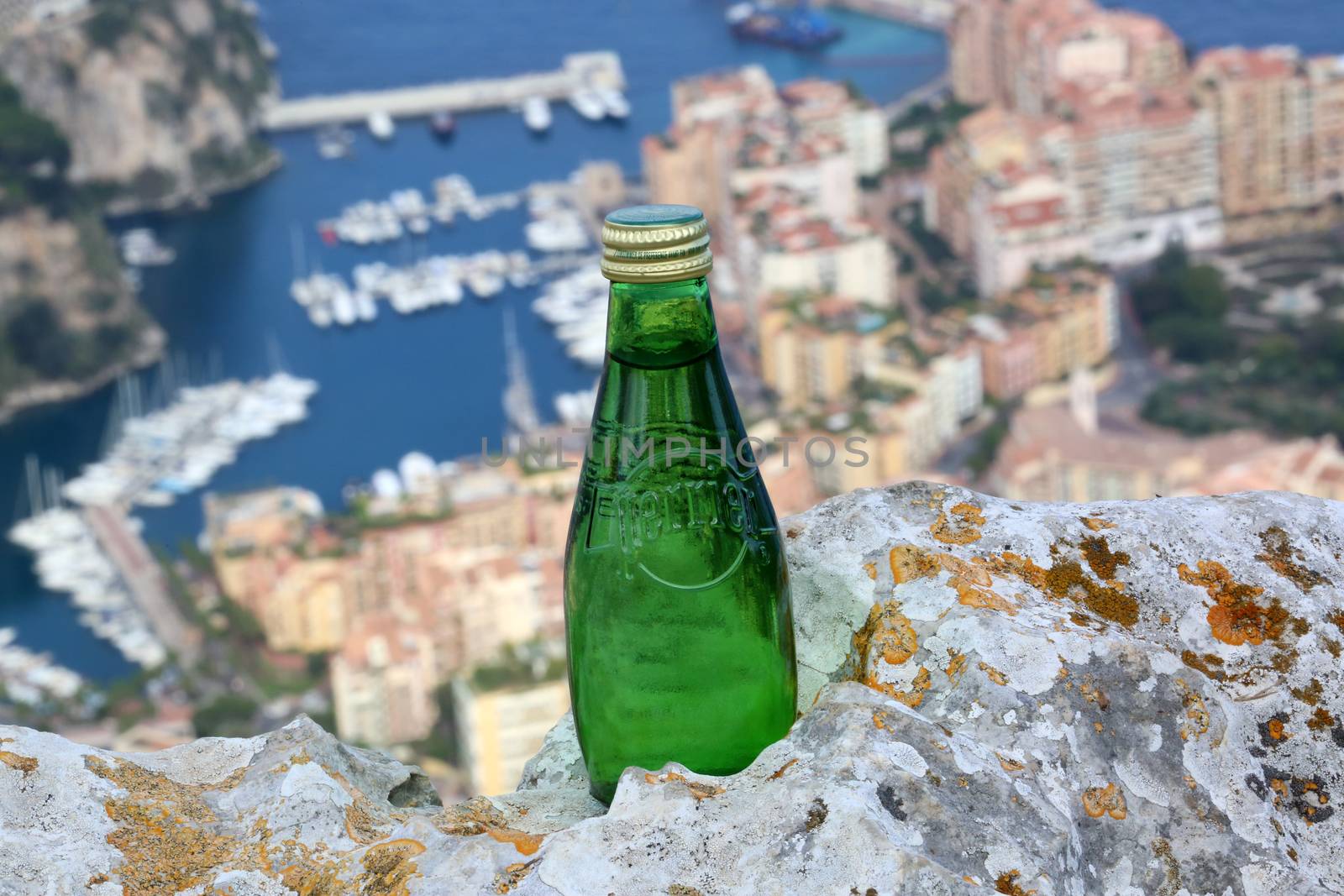 La Turbie, France - June 1, 2016: Perrier Sparkling Natural Mineral Water. Aerial View of the Port of Fontvieille in Monaco in the Background
