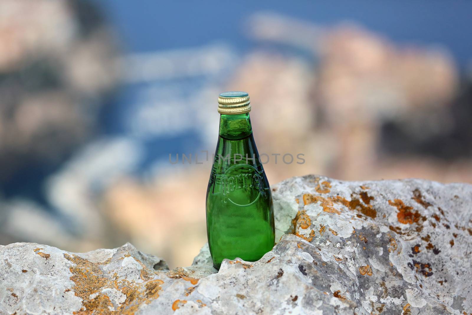 La Turbie, France - June 1, 2016: Perrier Sparkling Natural Mineral Water. Closeup of a Perrier Glass Bottle in The Nature