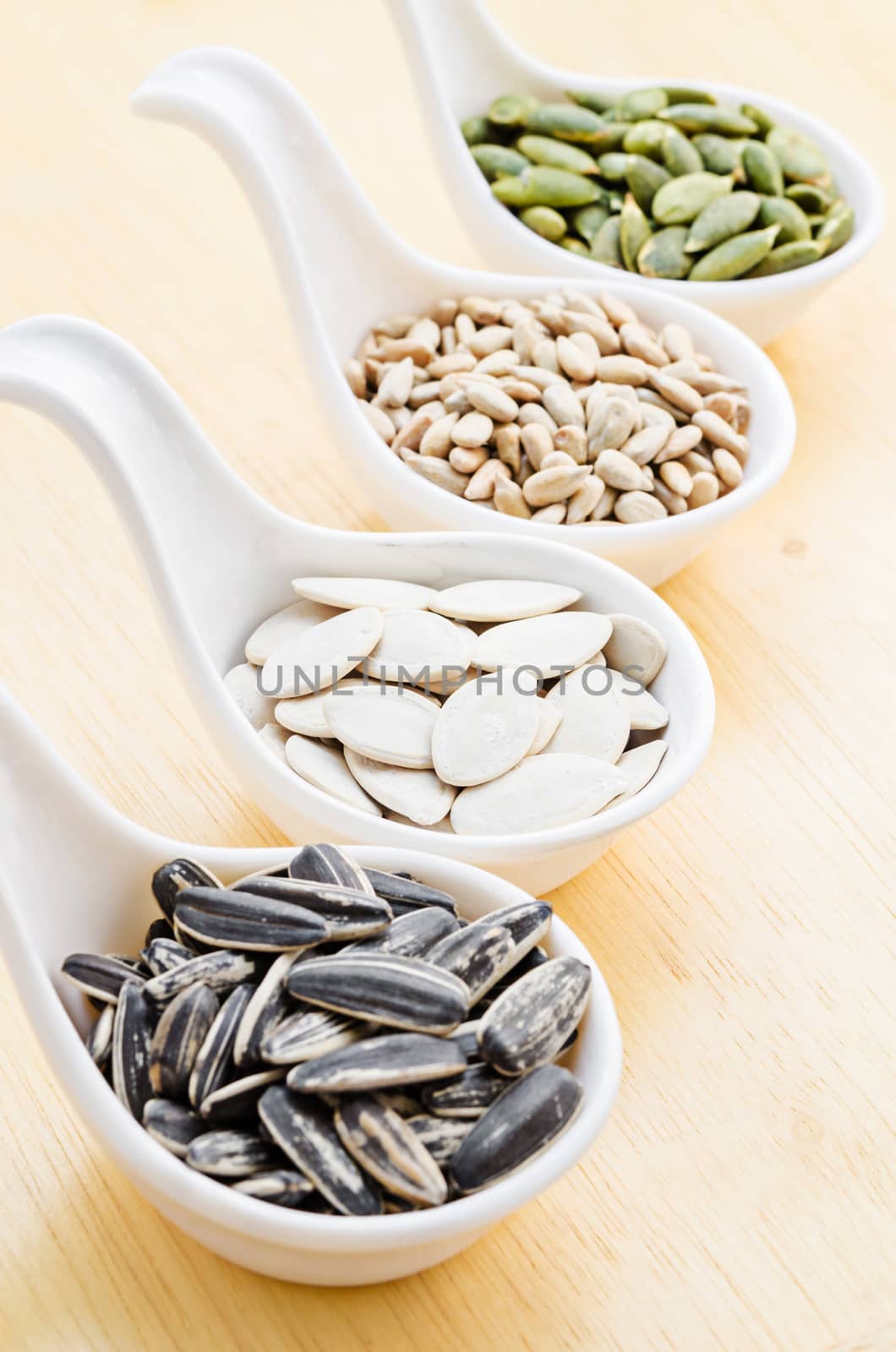 sunflower seeds and pumpkin seeds on wood background