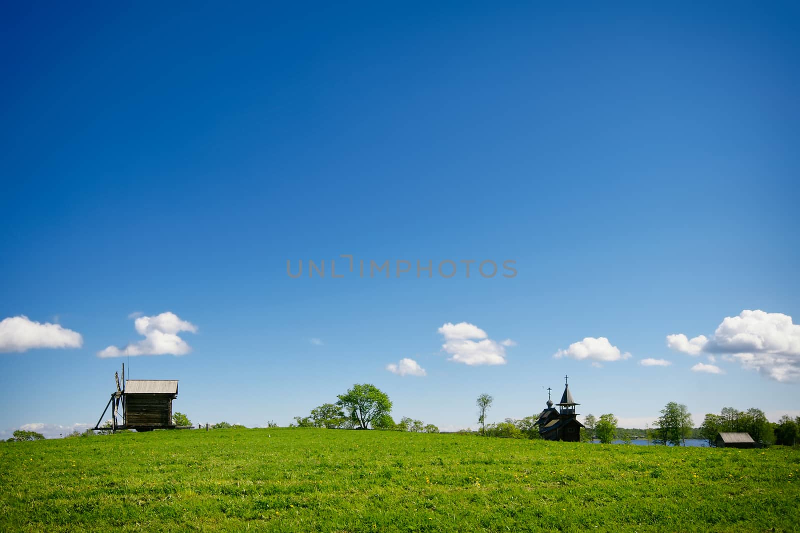 Green lanscape with one old windmill and blue sky, Russia