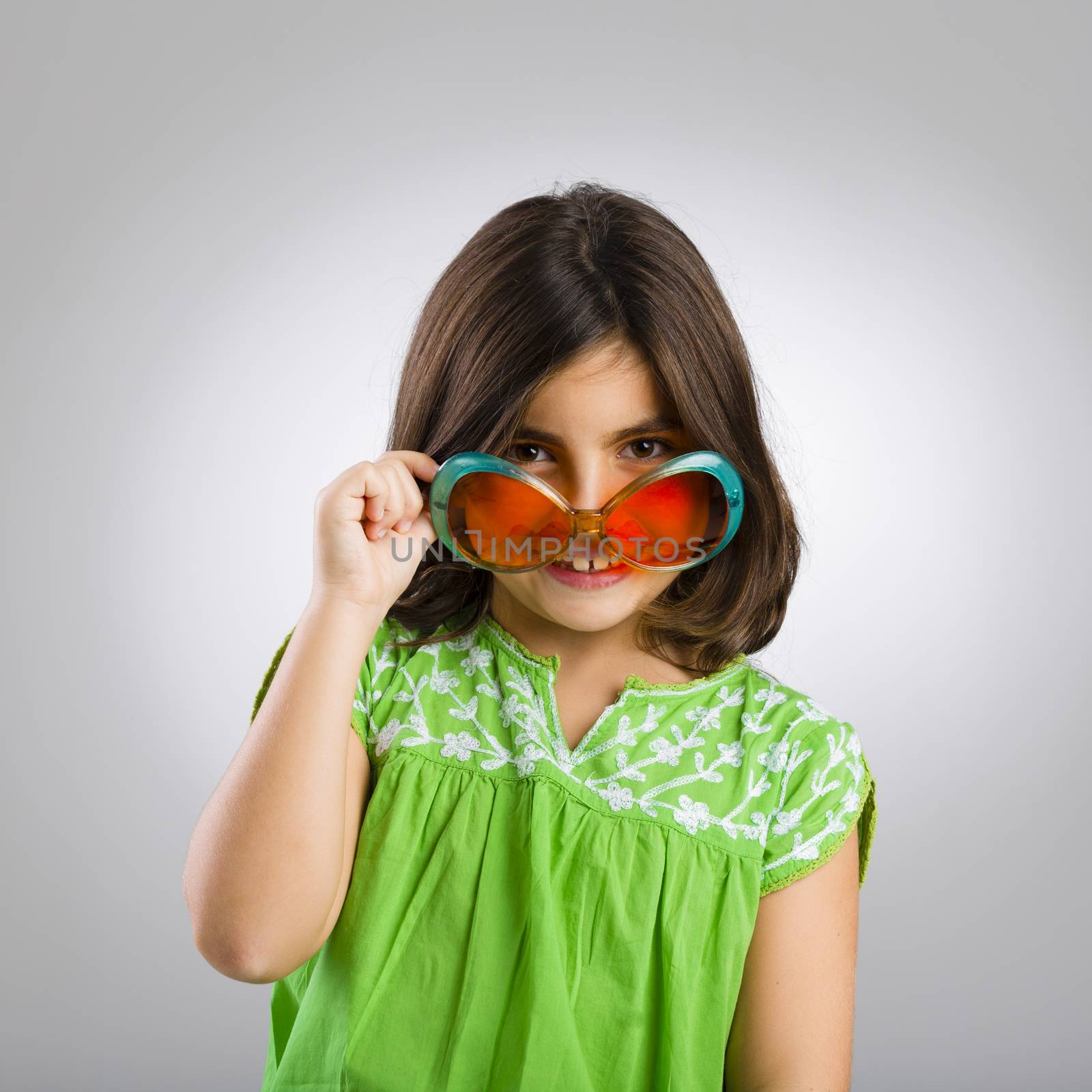 Portrait of a happy young girl wearing funny sunglasses