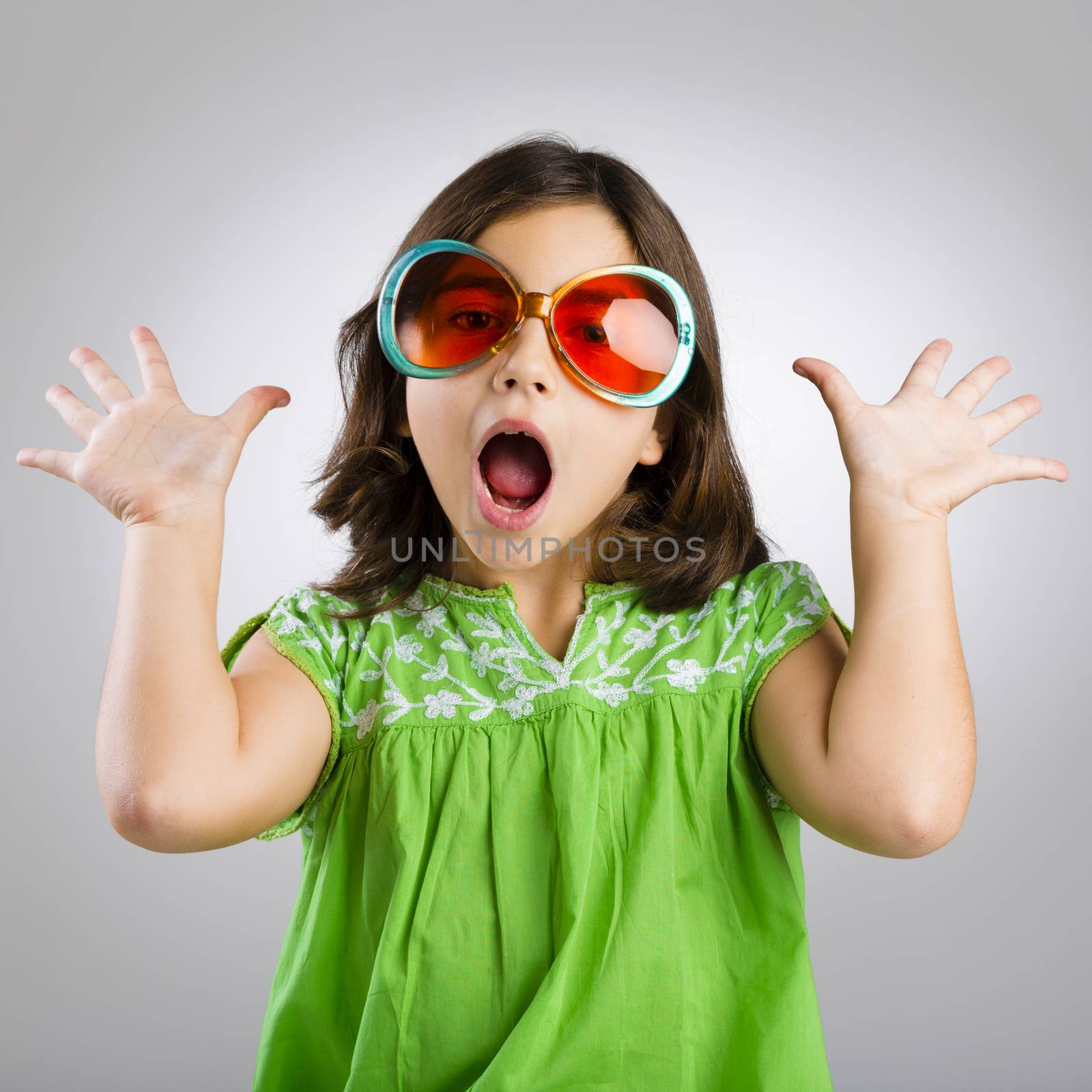 Portrait of a happy young girl wearing funny sunglasses