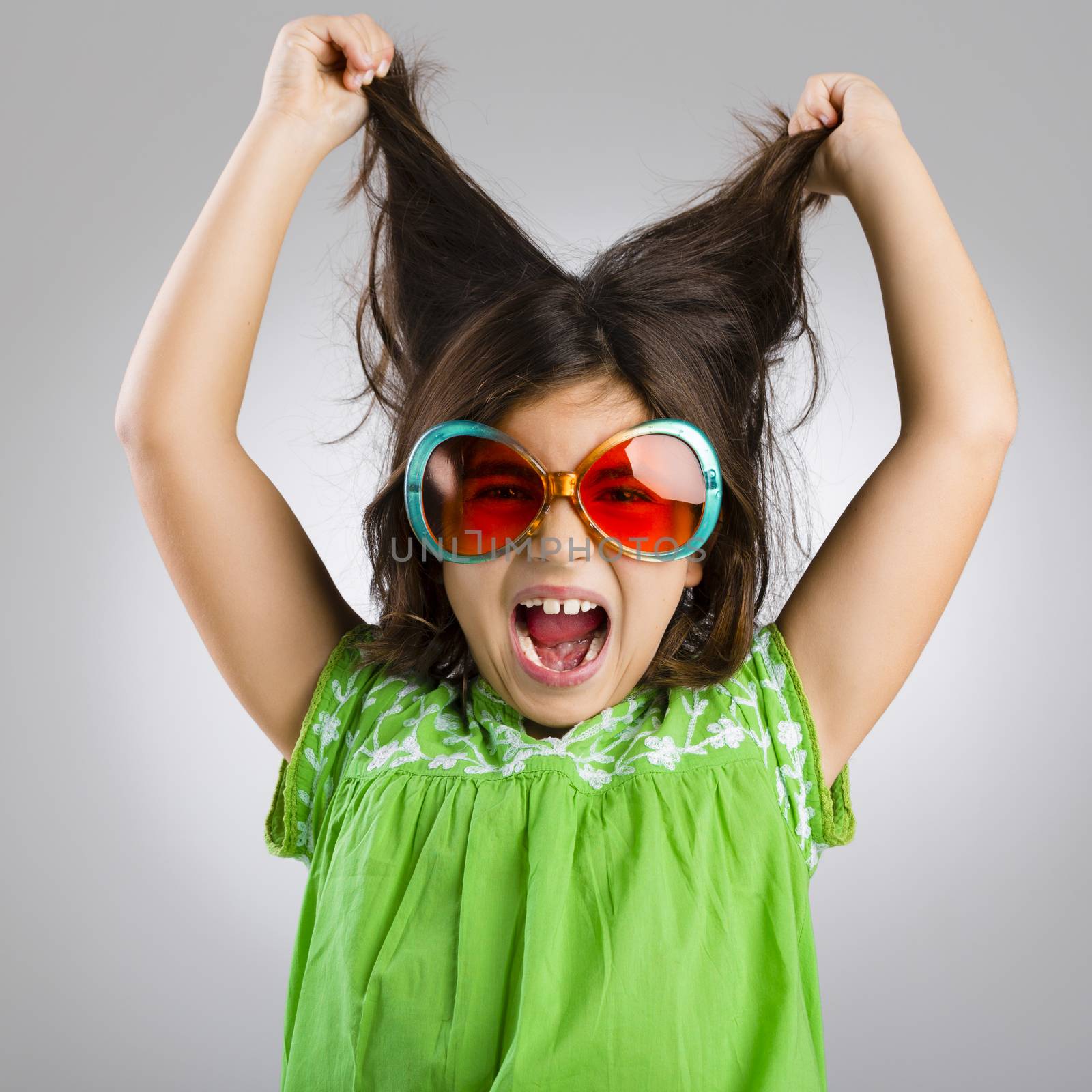 Portrait of a happy young girl wearing funny sunglasses