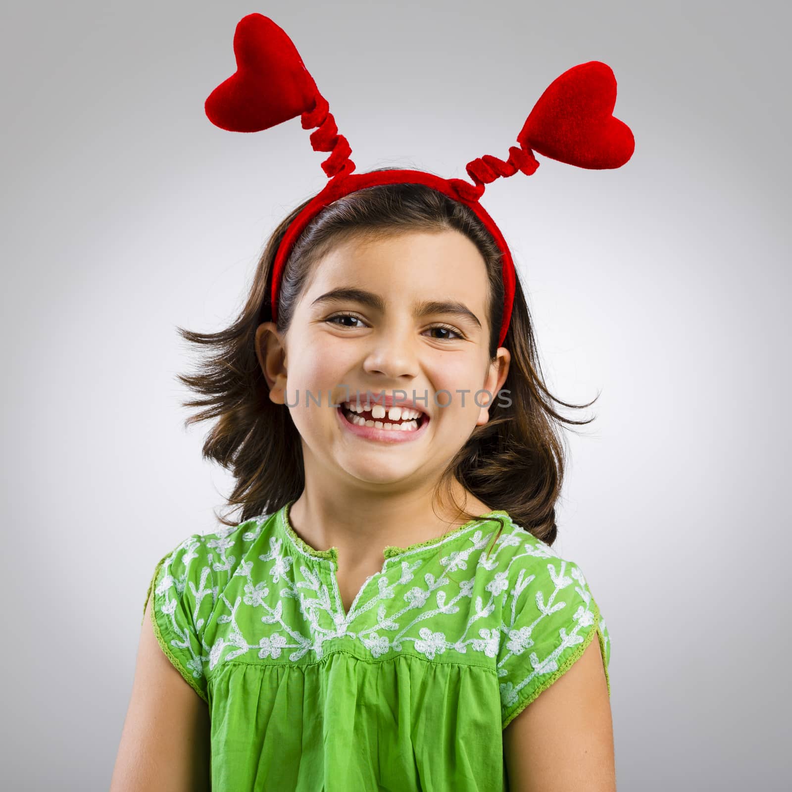 Studio portrait of a little girl wearing a headband with hearts