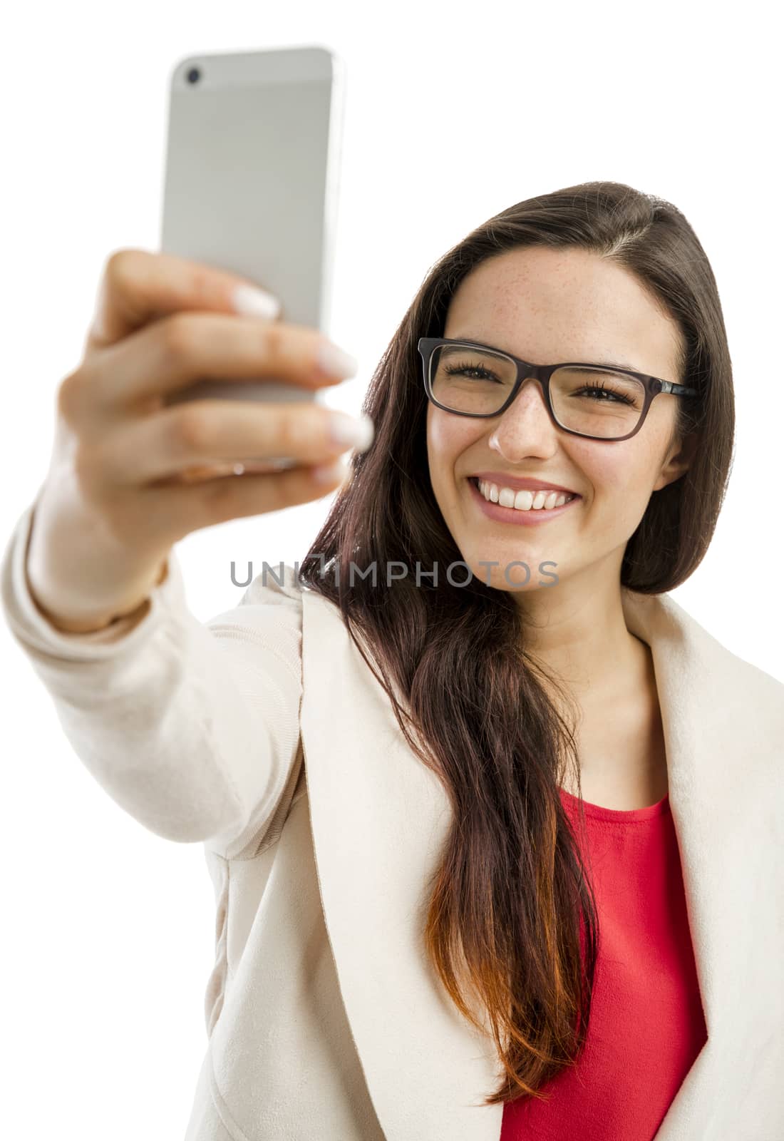 Beautiful woman making a  selfie with the phone, isolated over white background