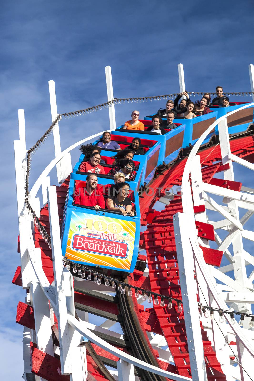 Santa Cruz, California, USA-November 15, 2014 : People on Giant Dipper the fifth oldest wooden coaster in the US. Built by Arthur Looff in 1924 and maximum speed is up to 46 mph. Taken in Santa Cruz Beach Boardwalk`s Park.