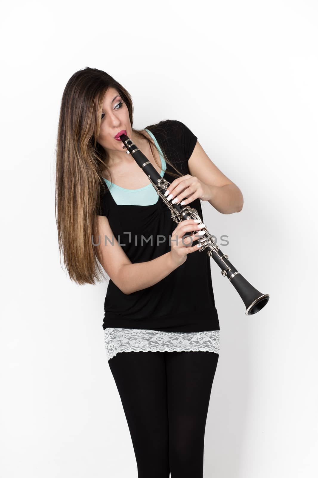 beautiful woman play clarinet on withe background 