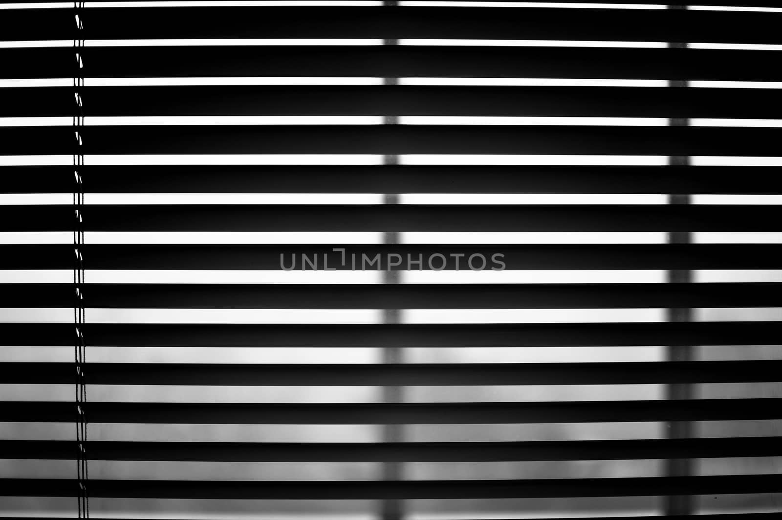 Closeup of semi open blinds in black and white.