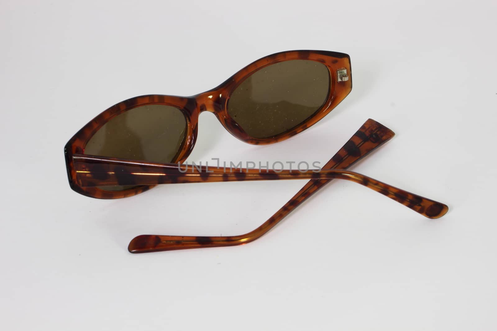 Broken sunglasses  with frame apart - isolated