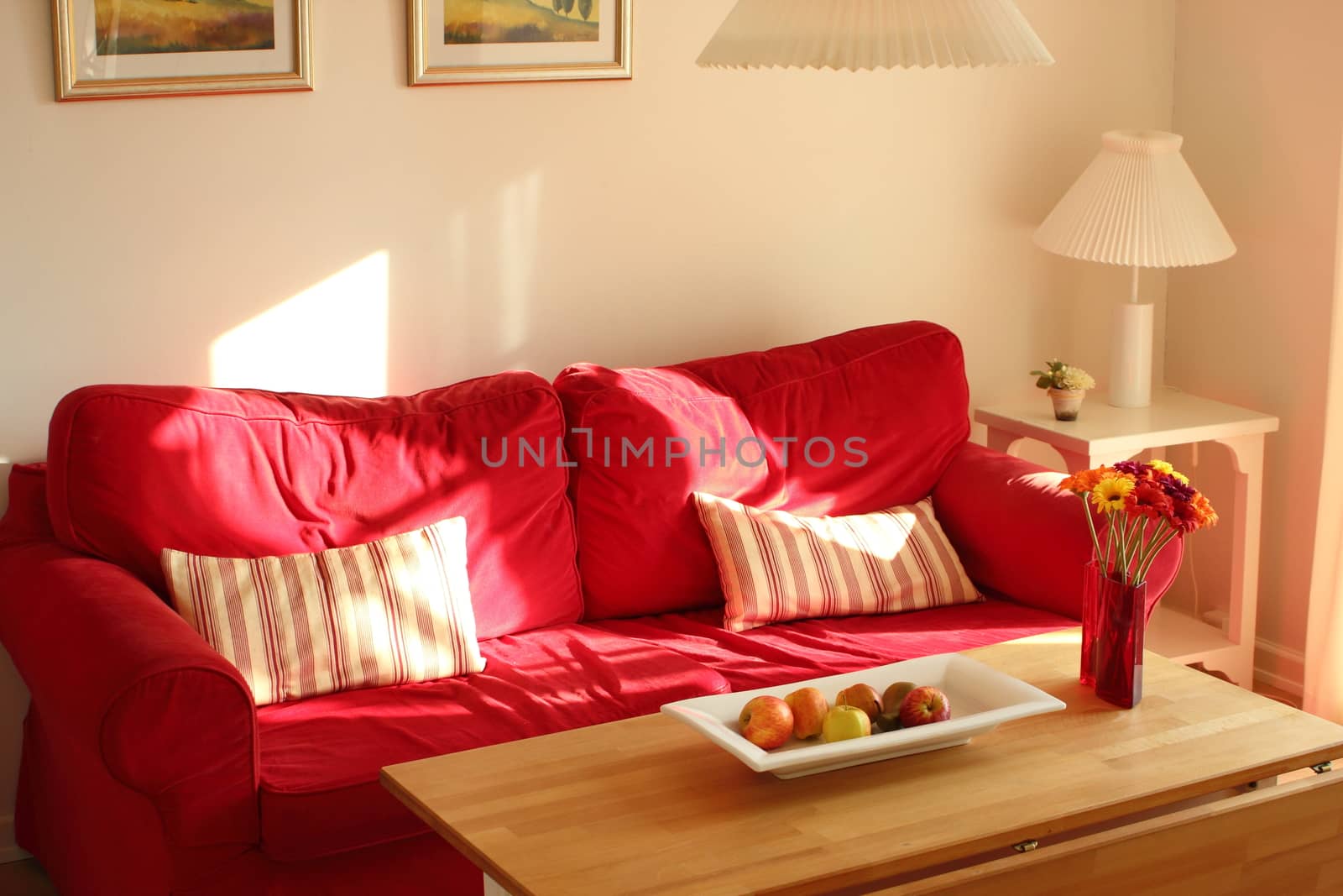 Cosy red couch in summerhouse in the afternoon by HoleInTheBox