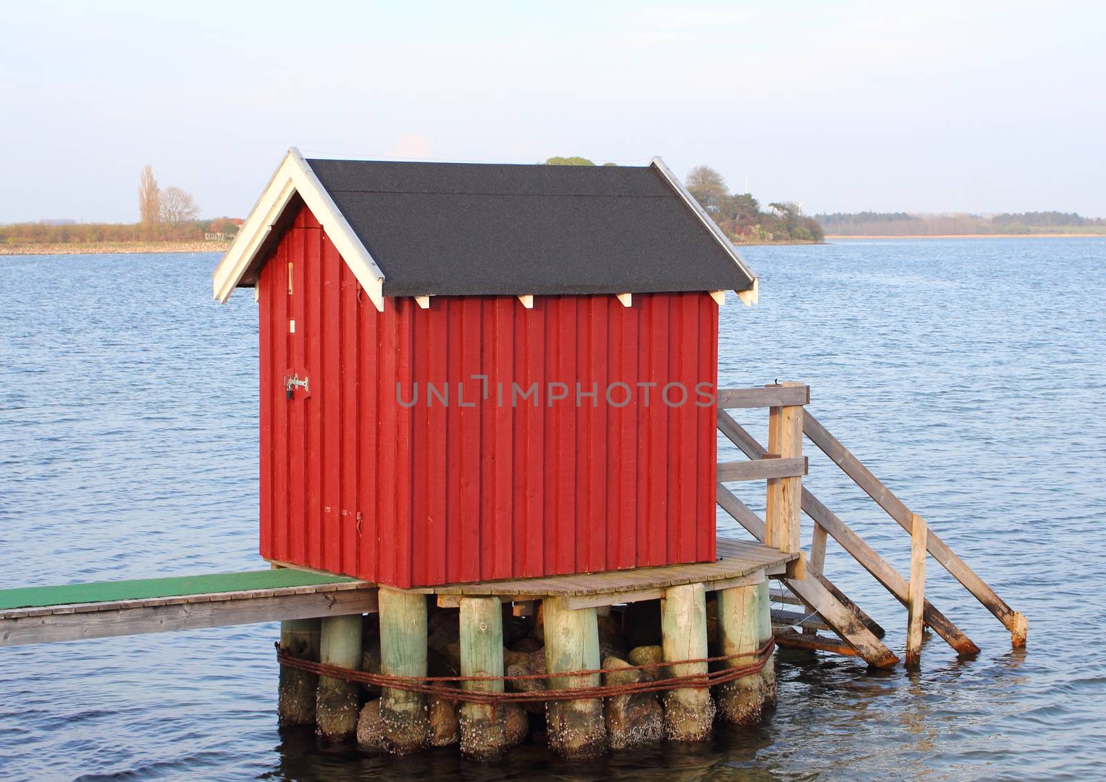 Swimmers dressing house at lake in Denmark by HoleInTheBox