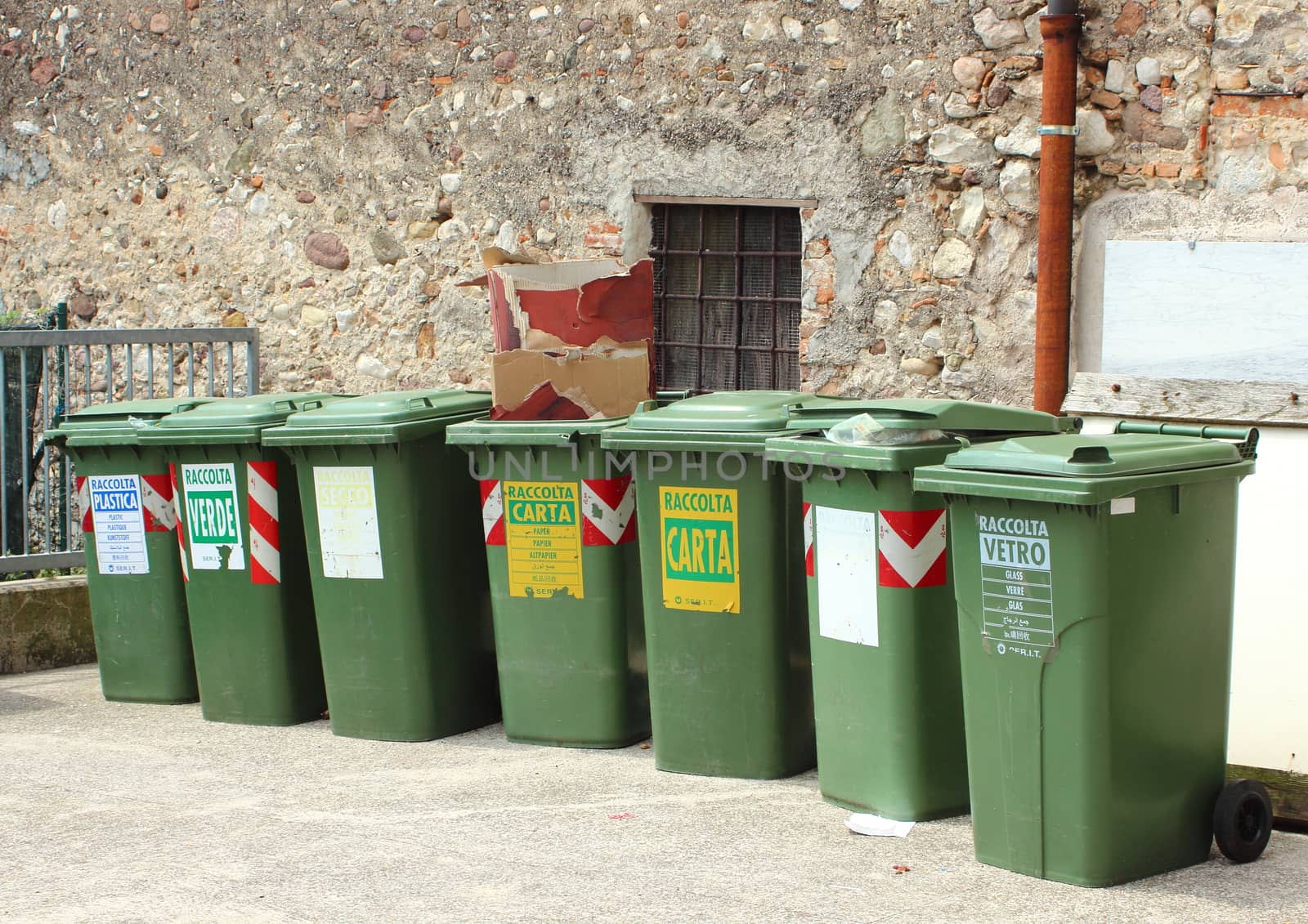 Line of garbage bin sorted for recycling by HoleInTheBox