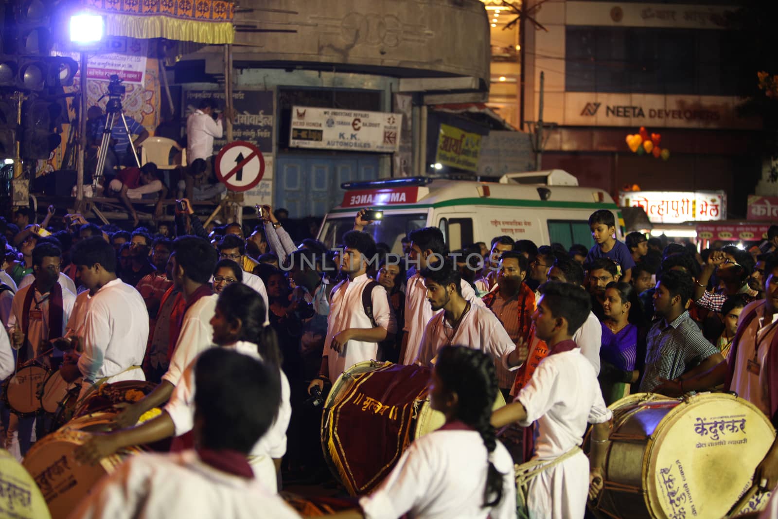 Pune, India - September 27, 2015: People in India dancing on the streets on the beats of traditional percussion instrument dhol, during a huge procession in the Ganesh festival