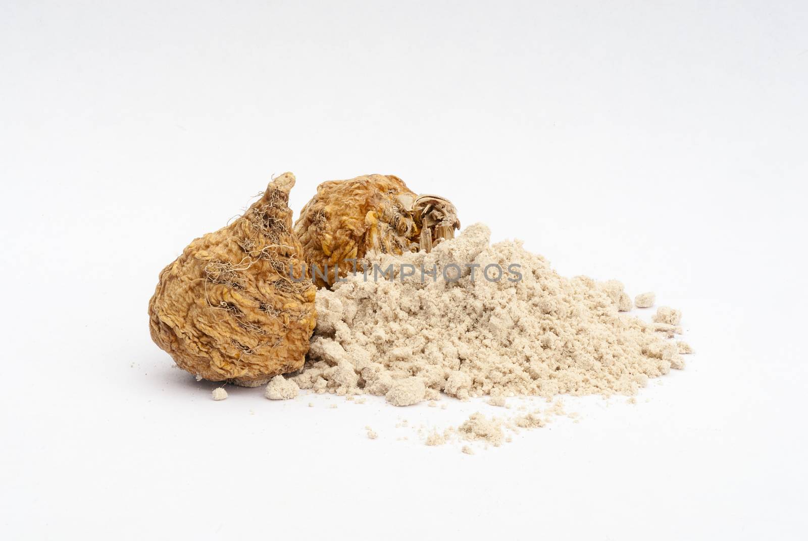 Peruvian ginseng or maca (Lepidium meyenii), dried root and  powder on wooden table