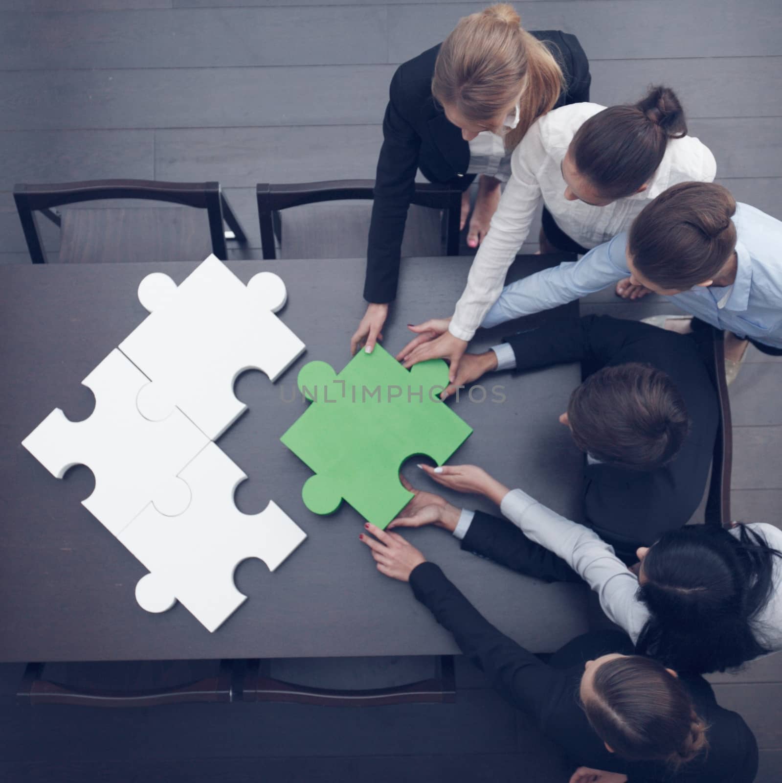 Business people assembling puzzle  by ALotOfPeople