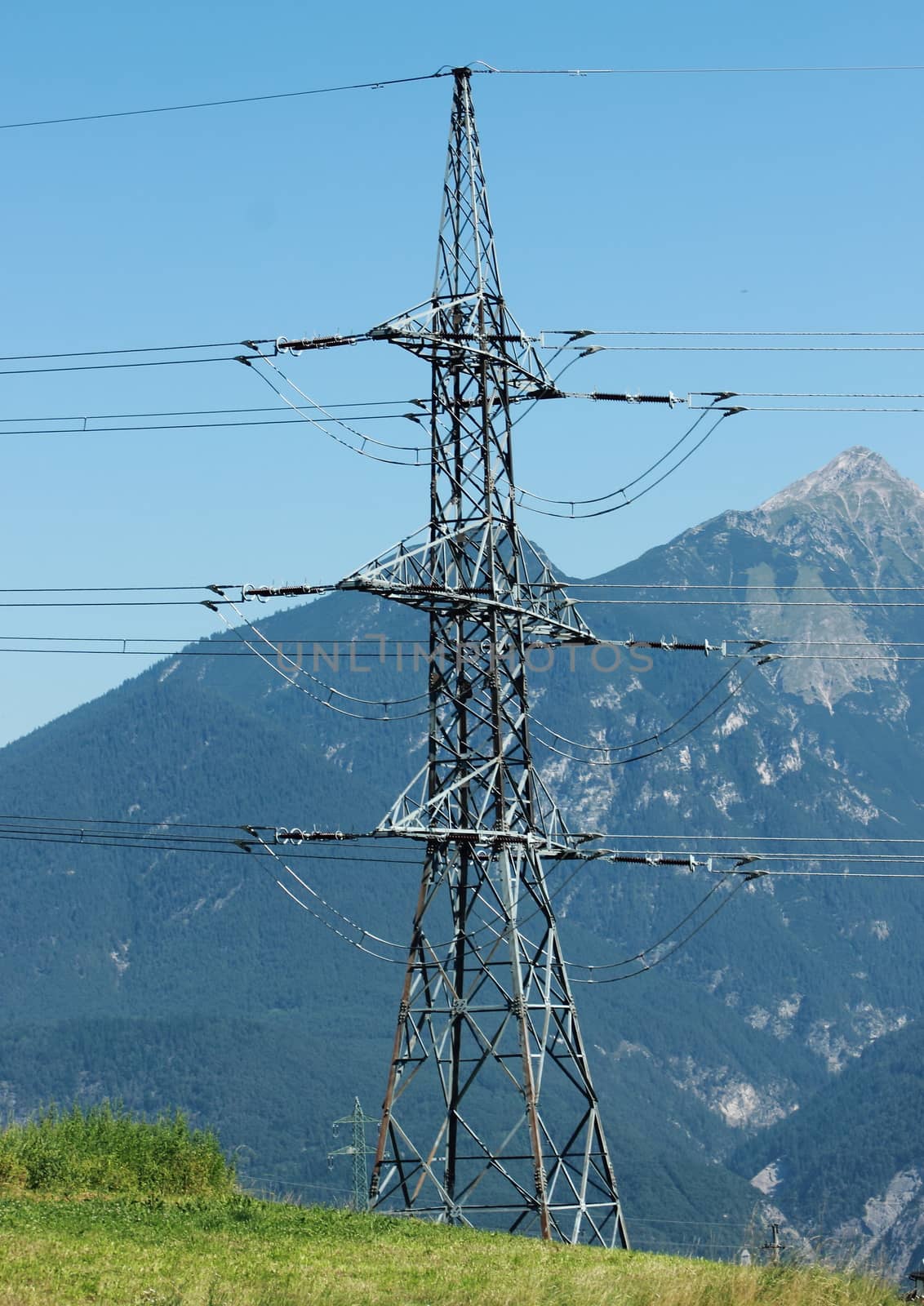 Pylon on mountain top with blue sky