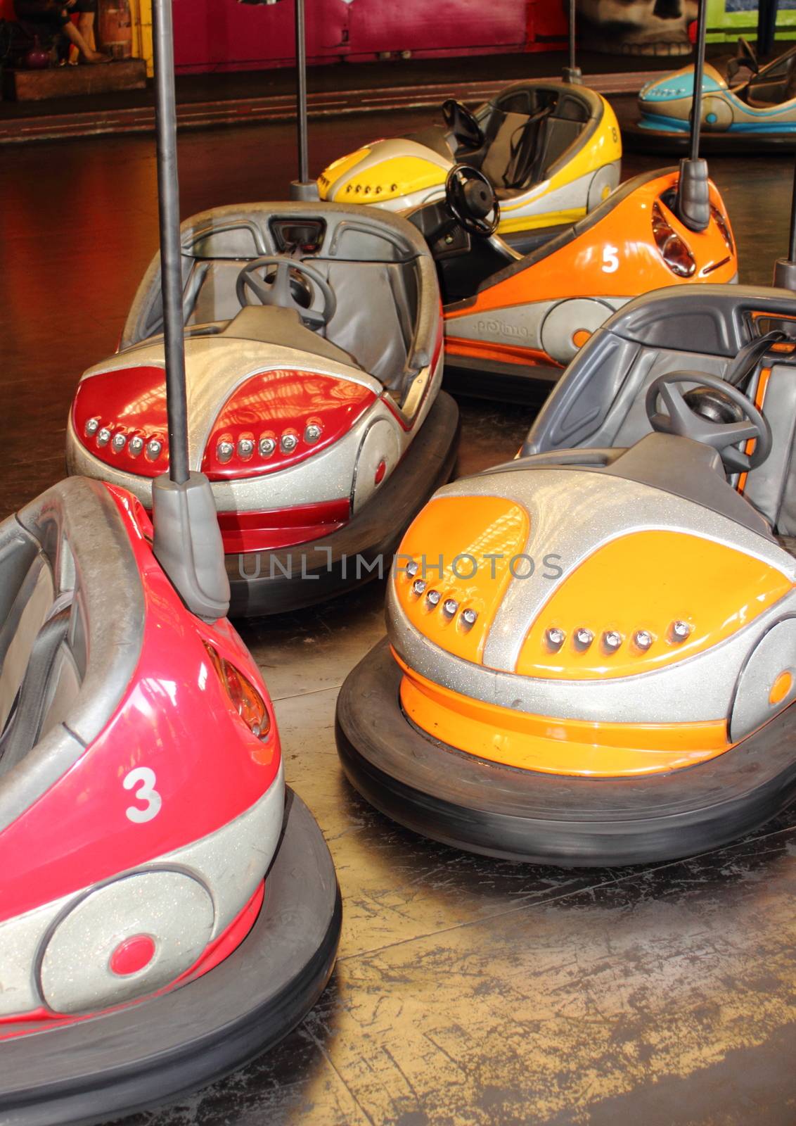 Empty red and orange bumper cars at fairground