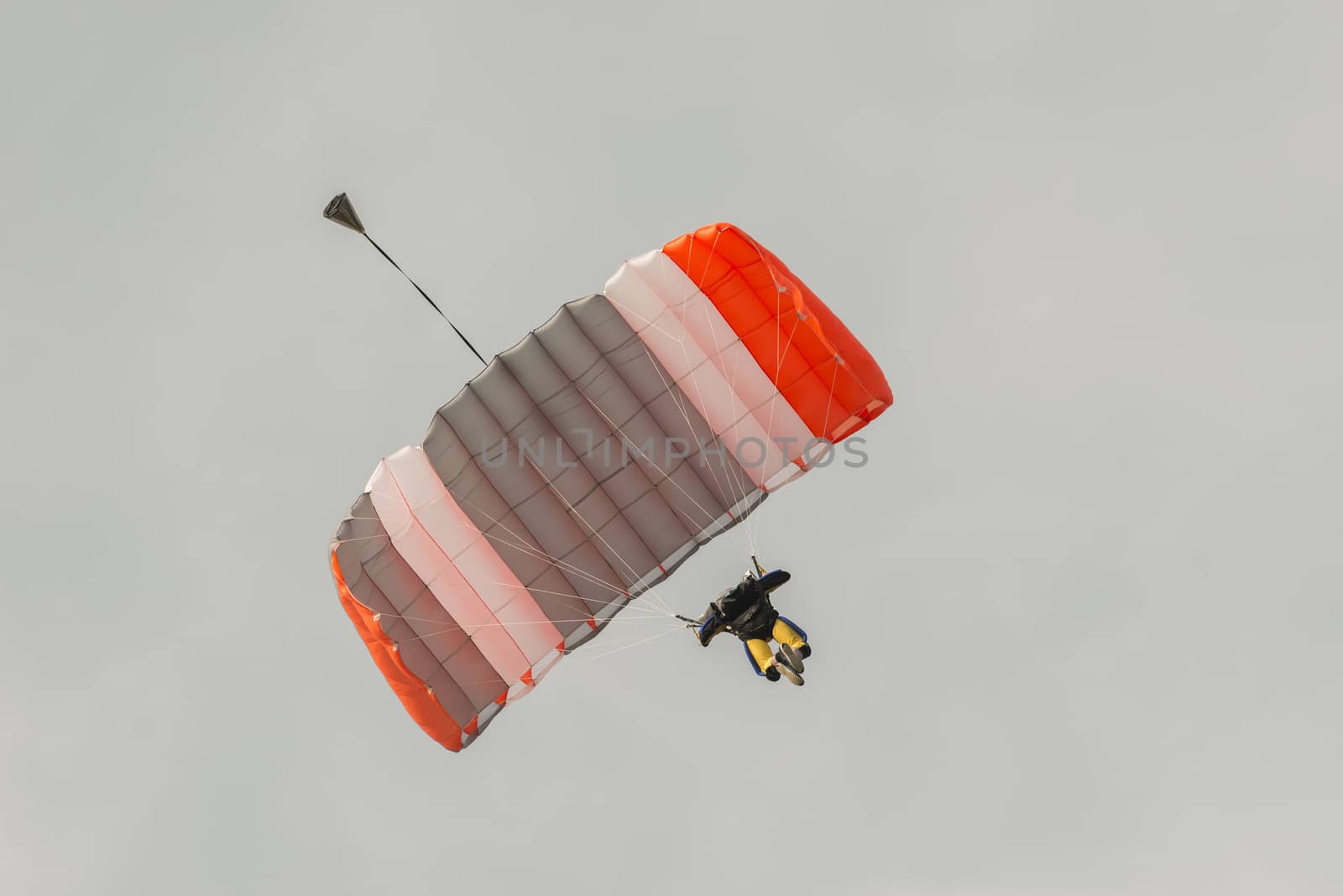 Parachutist floating to a square-shaped parachute
