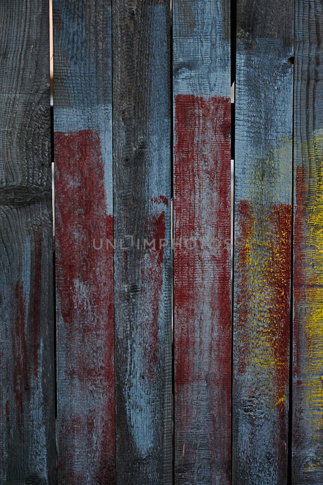 Old paint plank with holes and red blue color