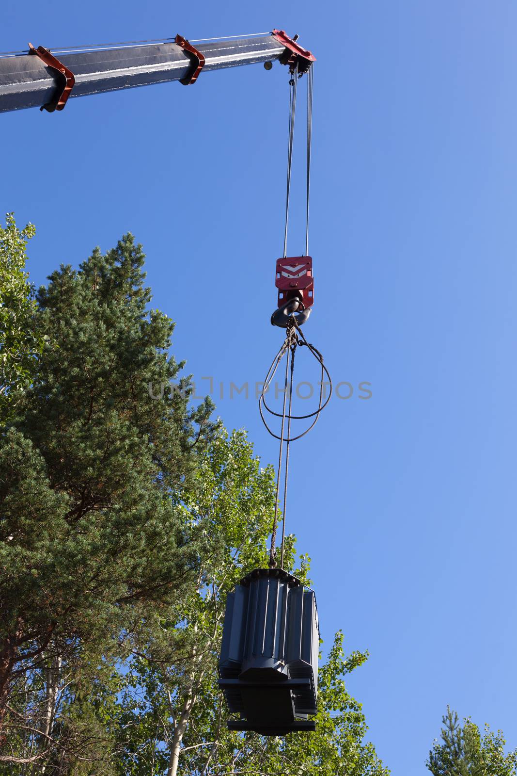 Crane hook lifts up the power transformer by AleksandrN