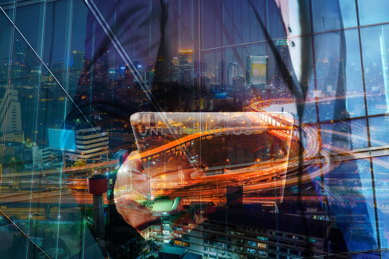 Double Exposure of BusinessMan hold Digital Tablet with Modern City Building and Highway as Digital Technology concept