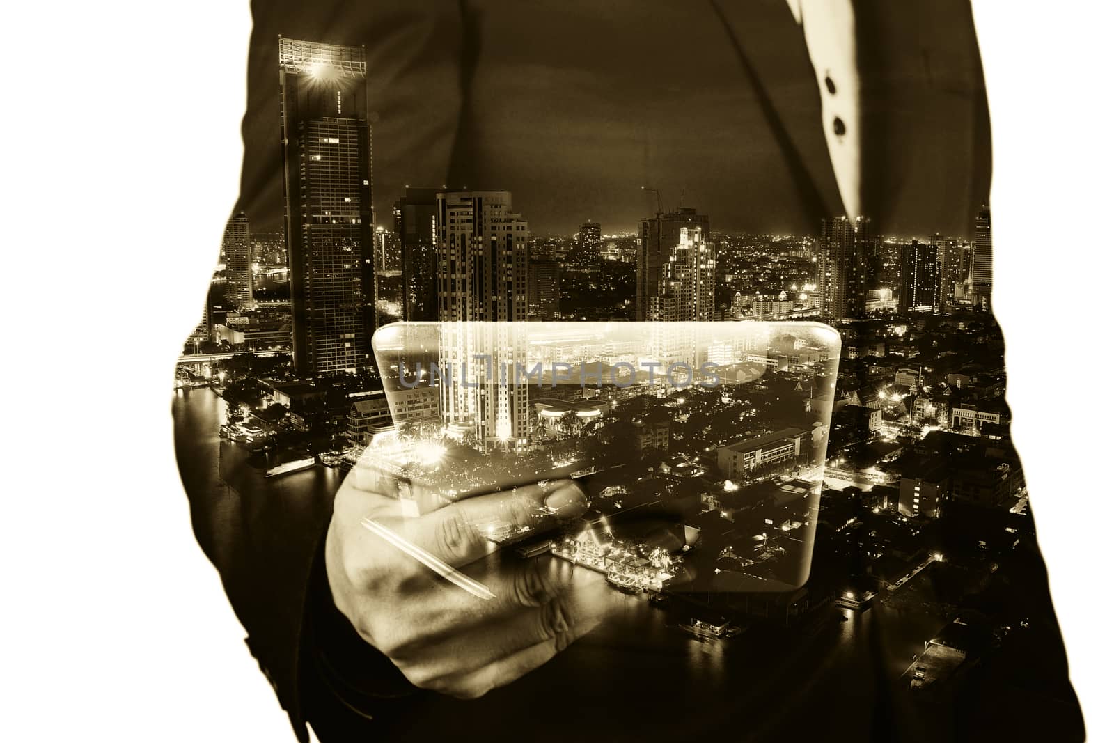 Double Exposure image of Businessman use Digital Tablet and City Building at Twilight as Business Technology concept