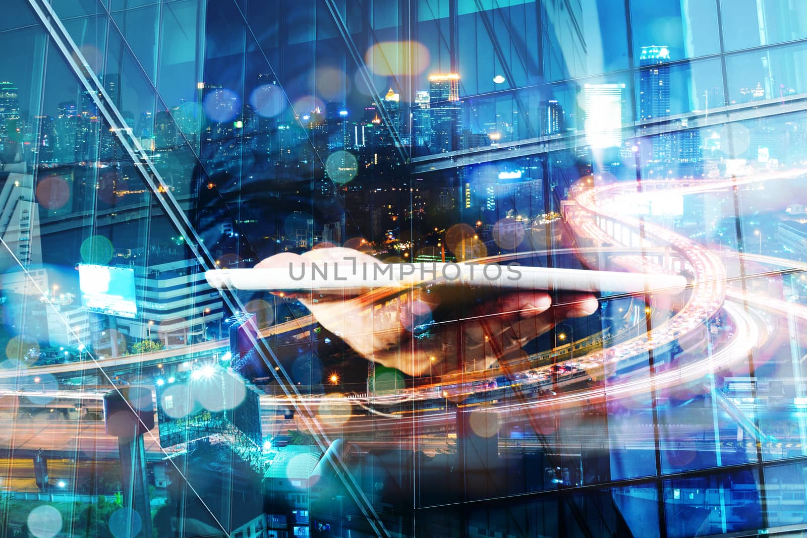 Double Exposure of BusinessMan hold Digital Tablet with Modern City Building and Highway as Digital Technology concept