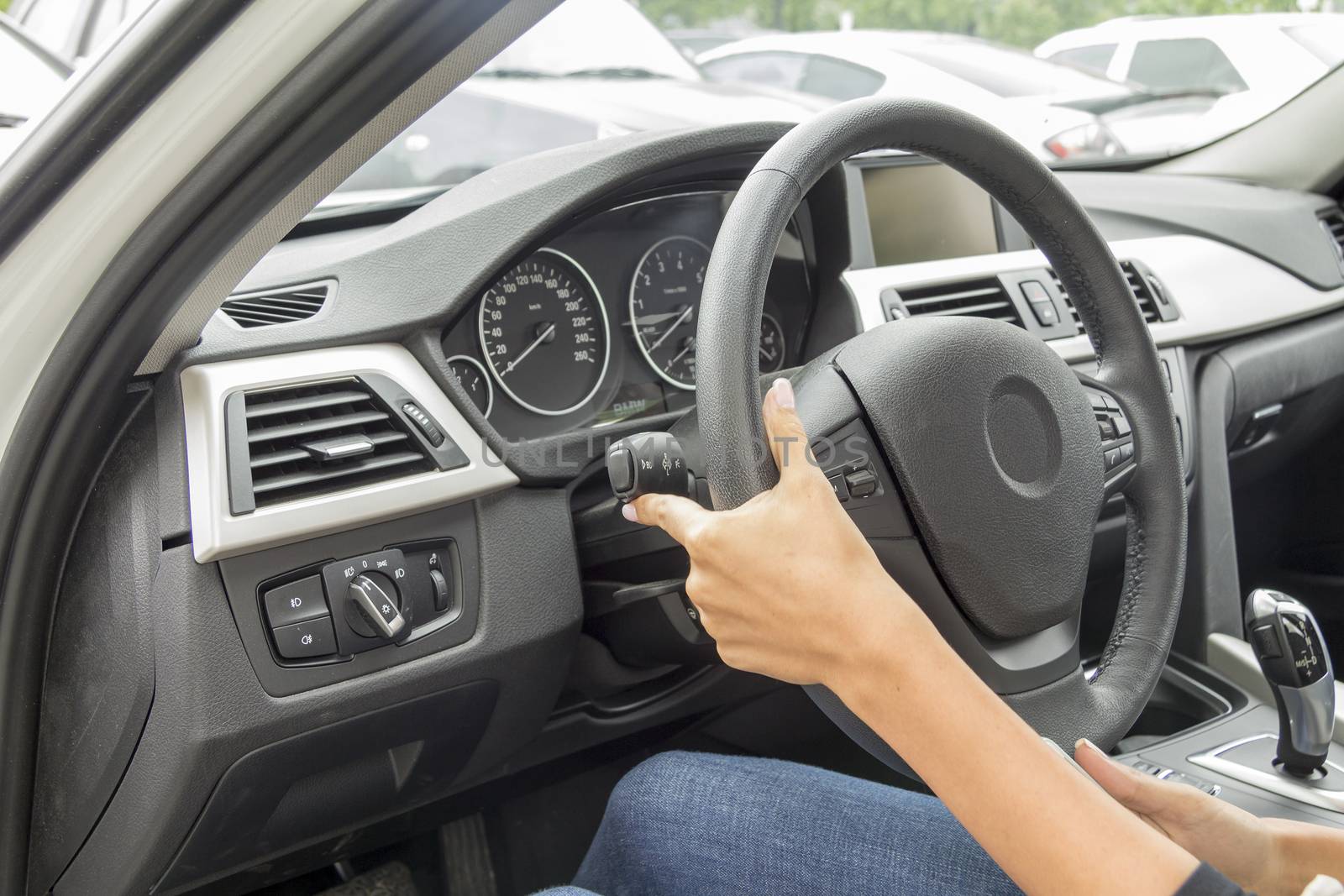 the girl with the manicure keeps hands on the steering wheel of the car