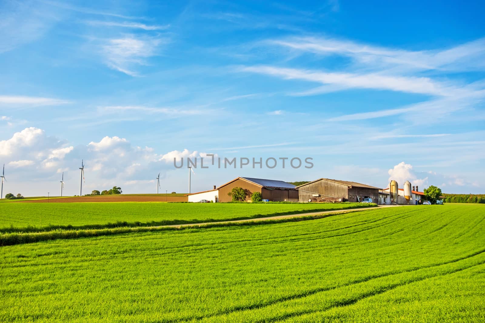 Bartholomae, Germany - May 26, 2016: Farm surrounded by green fields / meadow, blue sky