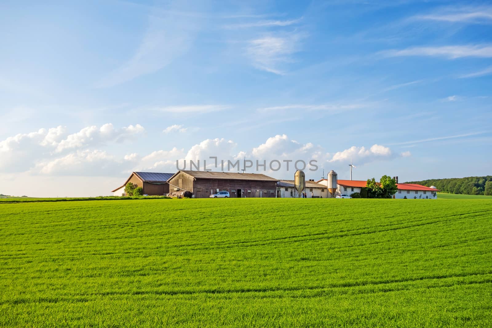 Bartholomae, Germany - May 26, 2016: Farm surrounded by green fields / meadow, blue sky