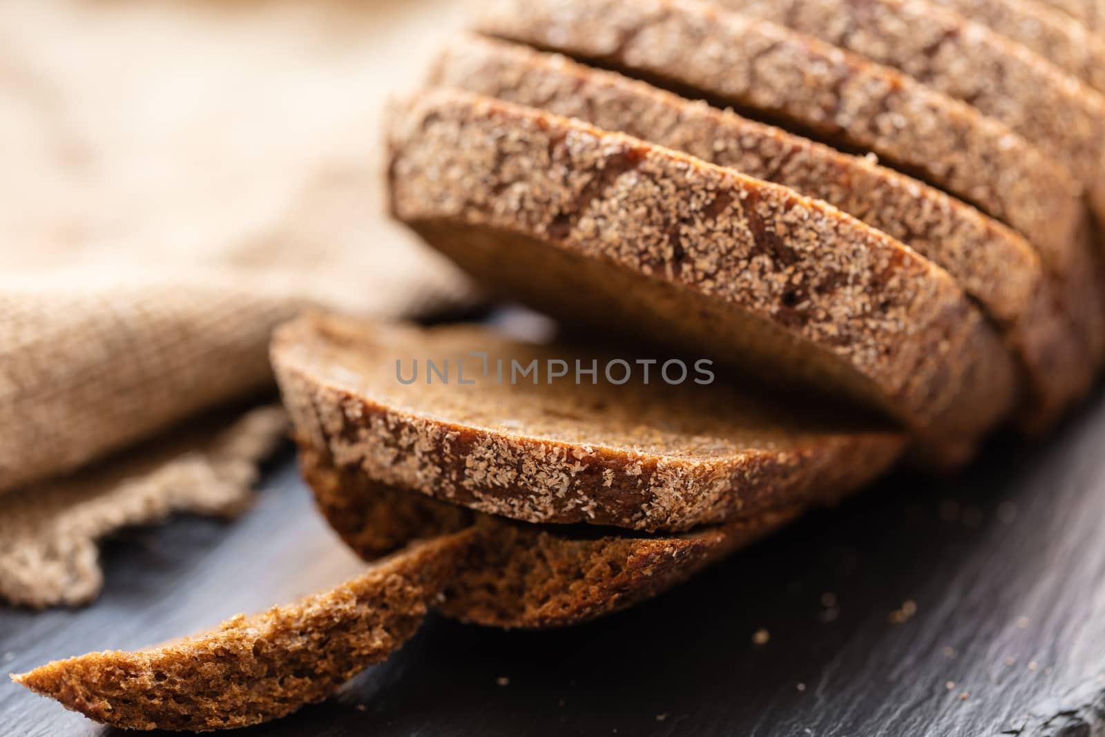 fresh sliced rye bread on a dark background