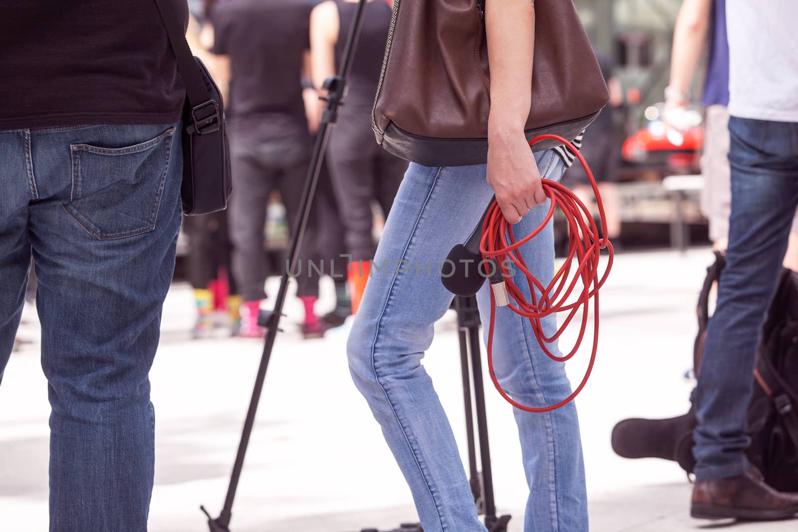 Female reporter holding mic, waiting for an media interview 