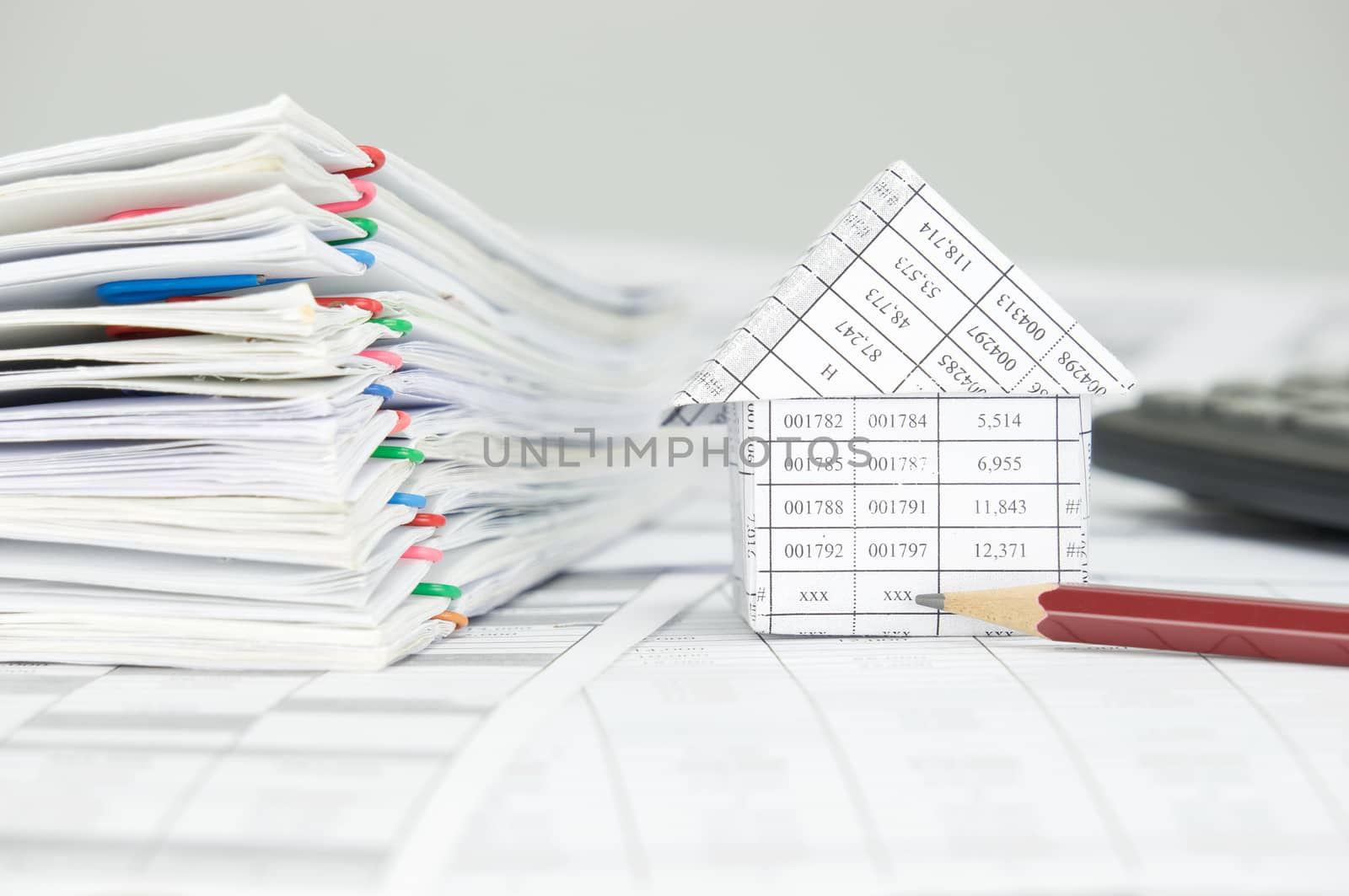 House with pencil and overload of paperwork on finance account by eaglesky