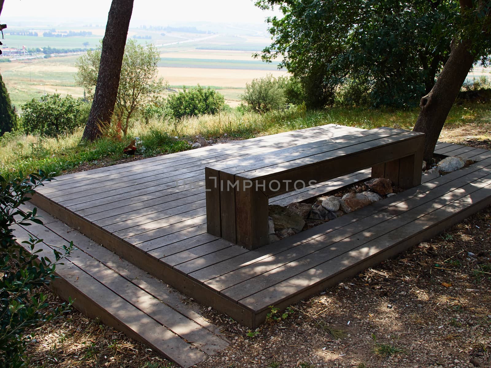 Modern design bench made of wood in a park overlooking beautiful landscape