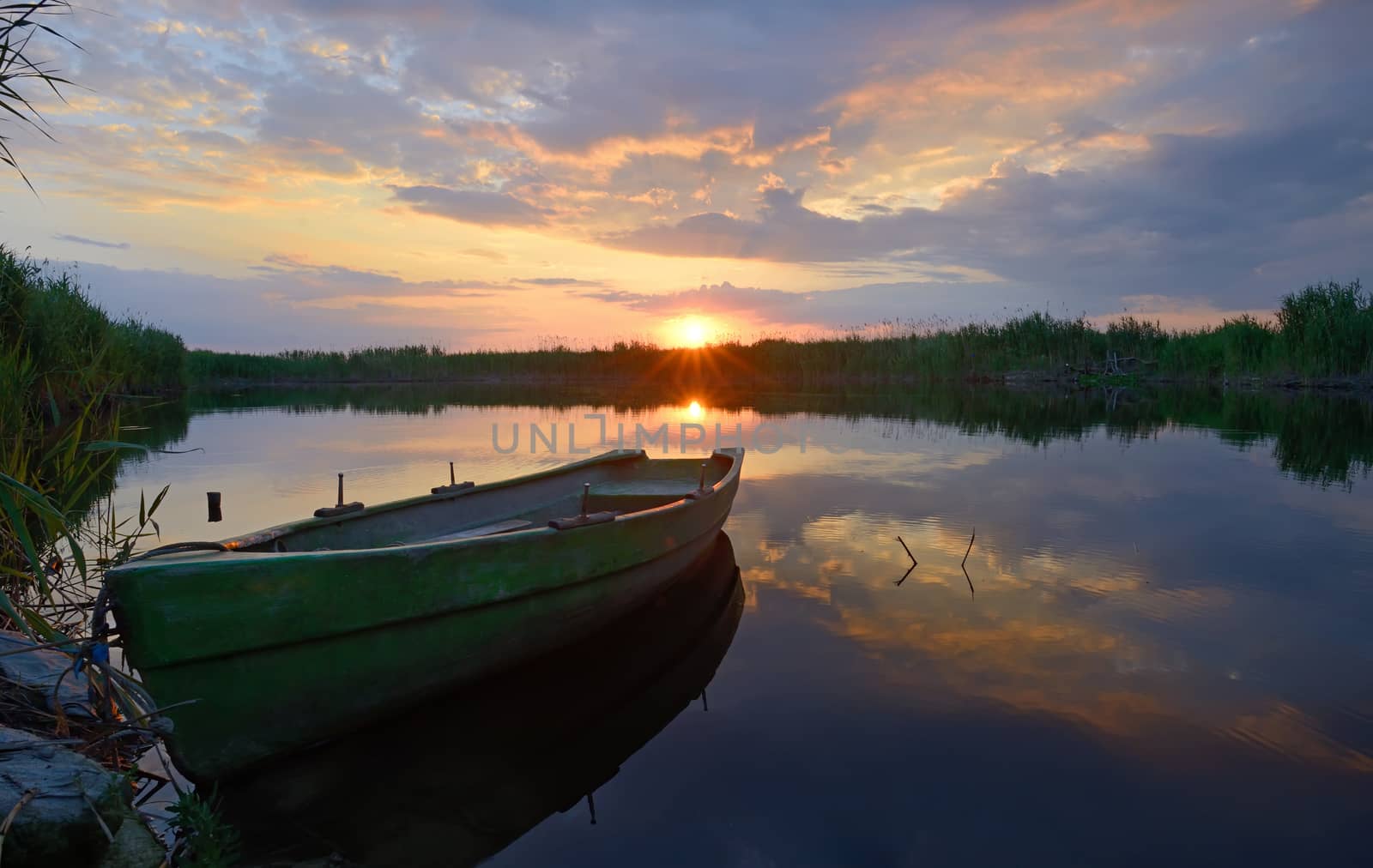fisherman boat at sunset in summer time