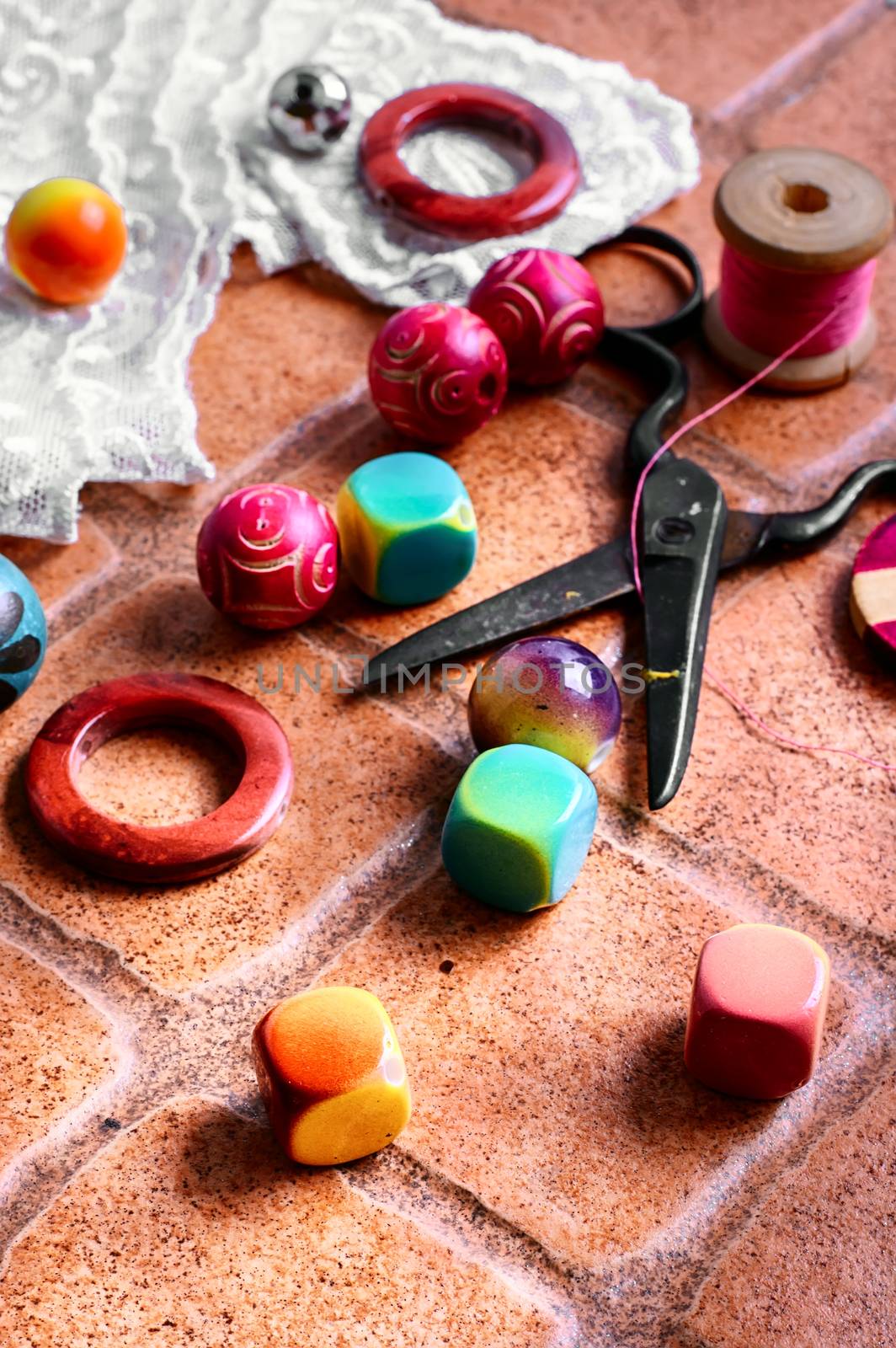 Set for needlework from thread and beads on a stone background